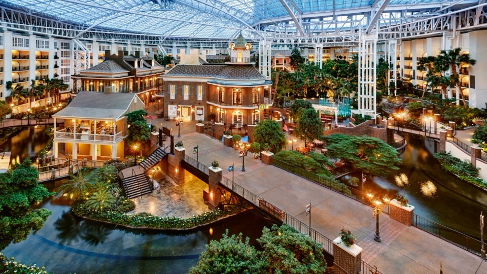 The Delta atrium at Gaylord Opryland Resort with indoor gardens, fountains, and balconies under glass
