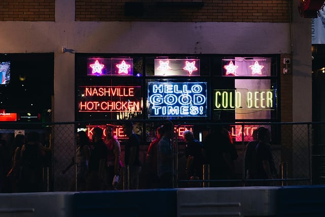 Neon signs glowing in a honky-tonk window on Lower Broadway at night